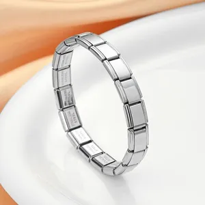 Macro view of polished silver stainless steel Italian charm bracelet with modular stretch links
