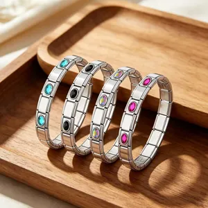 Close-up of four stainless steel modular link bracelets with colorful oval stones.