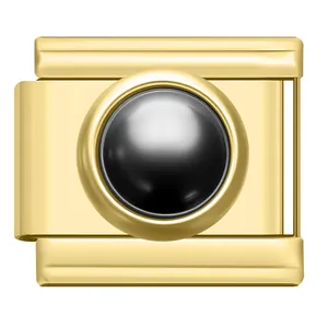 Primo piano di un charm italiano dorato con un elegante intarsio in perla nera lucida.