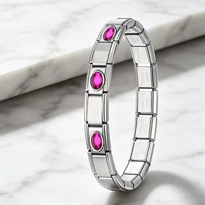 Close-up of a stainless steel modular bracelet featuring elegant pink oval crystal links