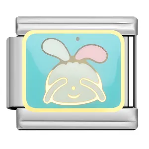 Detailed macro view of a cute bunny enamel charm on a stainless steel modular link bracelet