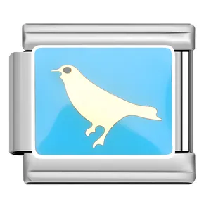 Detailed view of stainless steel modular charm with cream bird design on light blue background