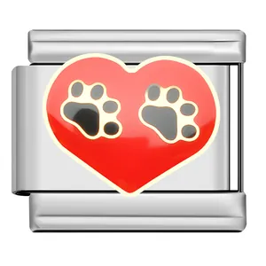 Macro detail of Italian modular charm with red heart and black paw prints design