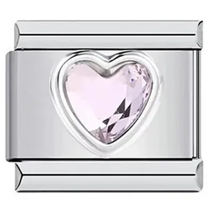 Close-up of a stainless steel Italian charm link featuring a pink heart-shaped crystal