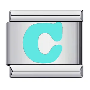 Detail view of a stainless steel Italian charm link with a light green letter C design