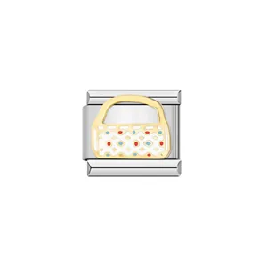 Detailed view of Italian modular charm featuring a gold handbag design with enamel motifs