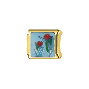 Close-up detail of a gold Italian link charm featuring blue enamel and red tulip flowers