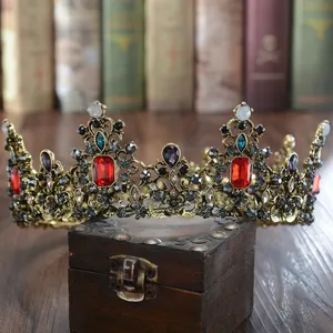 Detail van een luxe barokke cirkelvormige kroon met rode en blauwe kristallen op hout