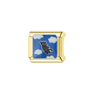 Close-up detail of a gold-plated Italian charm featuring a blue enamel sky and black cat