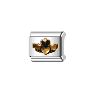 Detailed close-up of a silver modular charm with a gold-tone Claddagh heart symbol