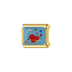 Close-up of golden Italian charm featuring red heart and moon enamel design