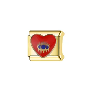 Close-up of gold-plated stainless steel Italian charm link with red heart and eye