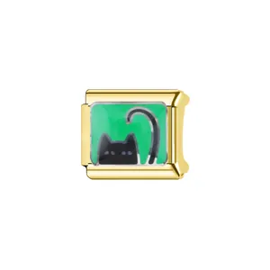 Close-up of a gold Italian modular charm featuring a cute black cat on green.