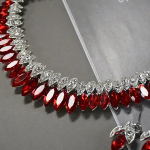 Close-up of luxury bridal necklace with vibrant red marquise-cut stones and clear zircons.