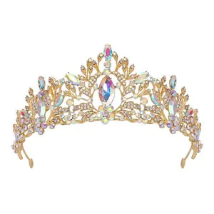 Detailed view of an ornate gold bridal tiara with sparkling iridescent rhinestones.