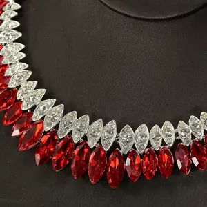 Close-up detail of a luxury bridal necklace featuring red marquise cut stones and crystals