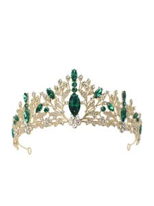 Detailed view of an elegant gold bridal tiara with sparkling green marquise gemstones