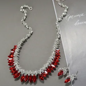 Detailed close-up of a luxurious bridal jewelry set with red gems and crystals