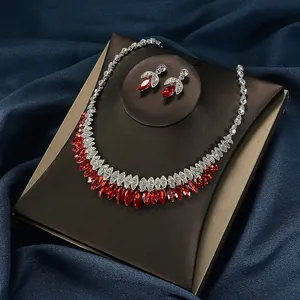 Luxury bridal jewelry set featuring red marquise-cut stones and sparkling crystals.