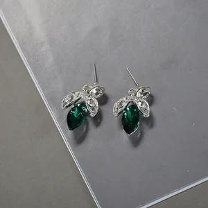 Elegant silver-tone stud earrings with emerald green marquise stones and zircon accents