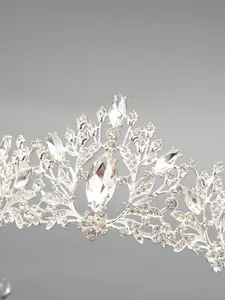 Exquisite macro view of a silver bridal tiara with sparkling crystal flower and leaf patterns