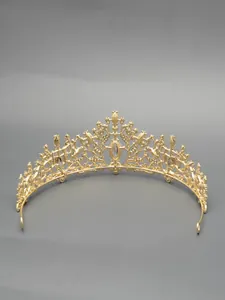 Elegant golden bridal tiara crown featuring intricate filigree metal details for weddings