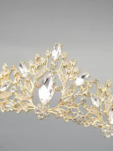 Detailed macro view of a golden bridal crown tiara featuring clear crystal floral patterns