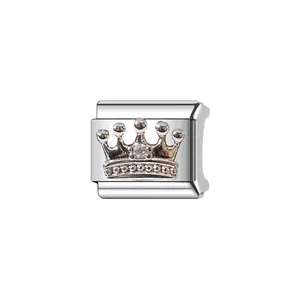 Close-up of silver-plated modular bracelet charm featuring an ornate crown design