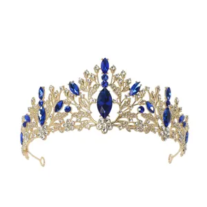 Elegant golden bridal tiara with blue gemstones and sparkling crystals for weddings.