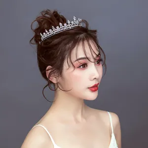 Elegant bridal tiara with sparkling crystals worn by an Asian model in an updo hairstyle.