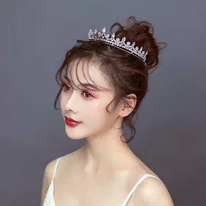 Elegant bridal crown tiara with sparkling crystals worn by an Asian model.