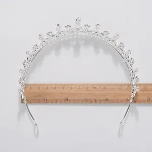 Silver crystal bridal crown tiara detail with wooden ruler showing width dimensions for size