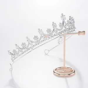 Elegant silver bridal tiara with sparkling rhinestones shown on a display stand