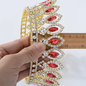 Detailed view of Baroque bridal crown with red rhinestones and scale measurement