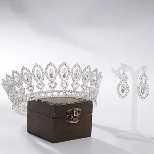 Baroque silver bridal tiara crown and dangling earrings wedding jewelry set on display