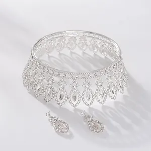 Detailed view of a silver Baroque bridal tiara and matching rhinestone earrings set