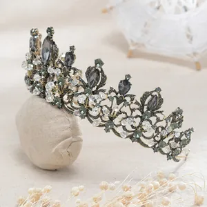 Close-up of vintage Baroque bridal crown with black crystals and ornate metalwork.