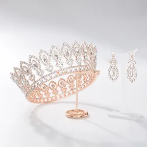 Detailed view of rose gold Baroque bridal tiara and matching rhinestone earrings