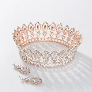 Elegant rose gold Baroque bridal crown and matching rhinestone drop earrings set for weddings.