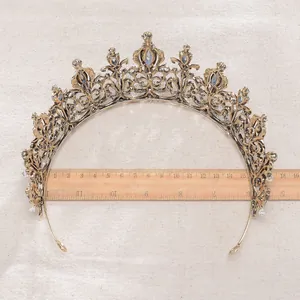 Close-up of a vintage Baroque bronze bridal tiara with crystals and measuring ruler