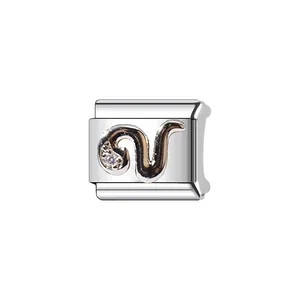 Close-up detail of stainless steel Italian modular charm with a silver snake stone design