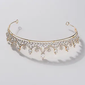 Elegant gold bridal tiara crown featuring intricate sparkling crystal floral scalloped patterns