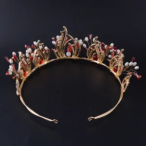 Macrodetail van barokke gouden bruidskroon met rode kristallen en witte kralen