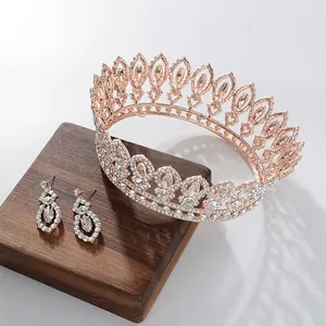 Detailed macro of rose gold baroque bridal tiara and matching rhinestone earrings set
