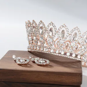 Close-up of rose gold Baroque bridal crown and earrings with sparkling rhinestones