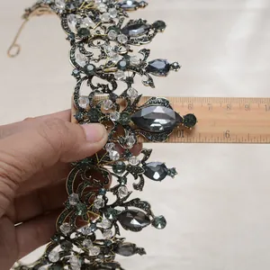 Macro detail view of a vintage Baroque black crystal bridal crown with ruler for size