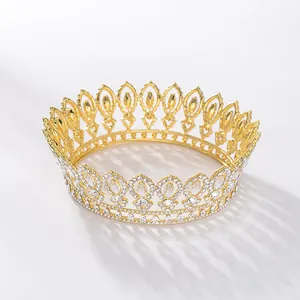 Detail shot of a golden Baroque wedding crown featuring intricate white crystal embellishments