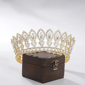 Detailed macro shot of a golden Baroque bridal tiara with sparkling clear crystals