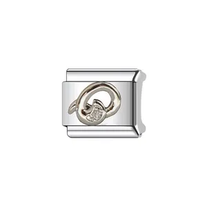 Detailed macro view of a silver stainless steel Italian charm link with letter Q decoration
