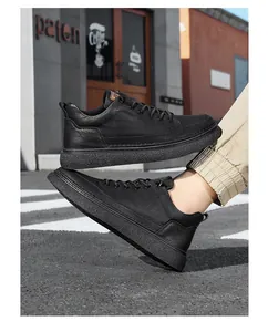 Detailed view of stylish black leather casual sneakers for men in an urban outdoor setting.